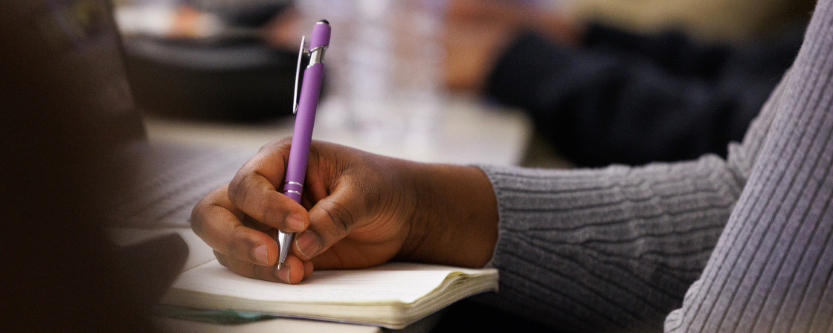 Hand writing on pad of paper