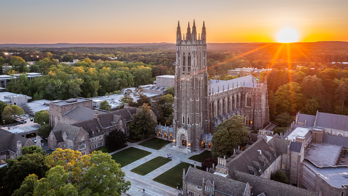 view of the Duke Chapel and Abel quad against a setting sun