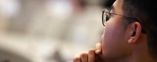 MMCi student with hand to chin
